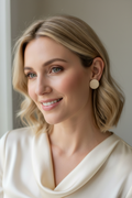 White woman wearing Cloud & Cream Gloss Stud Earrings lifestyle photo